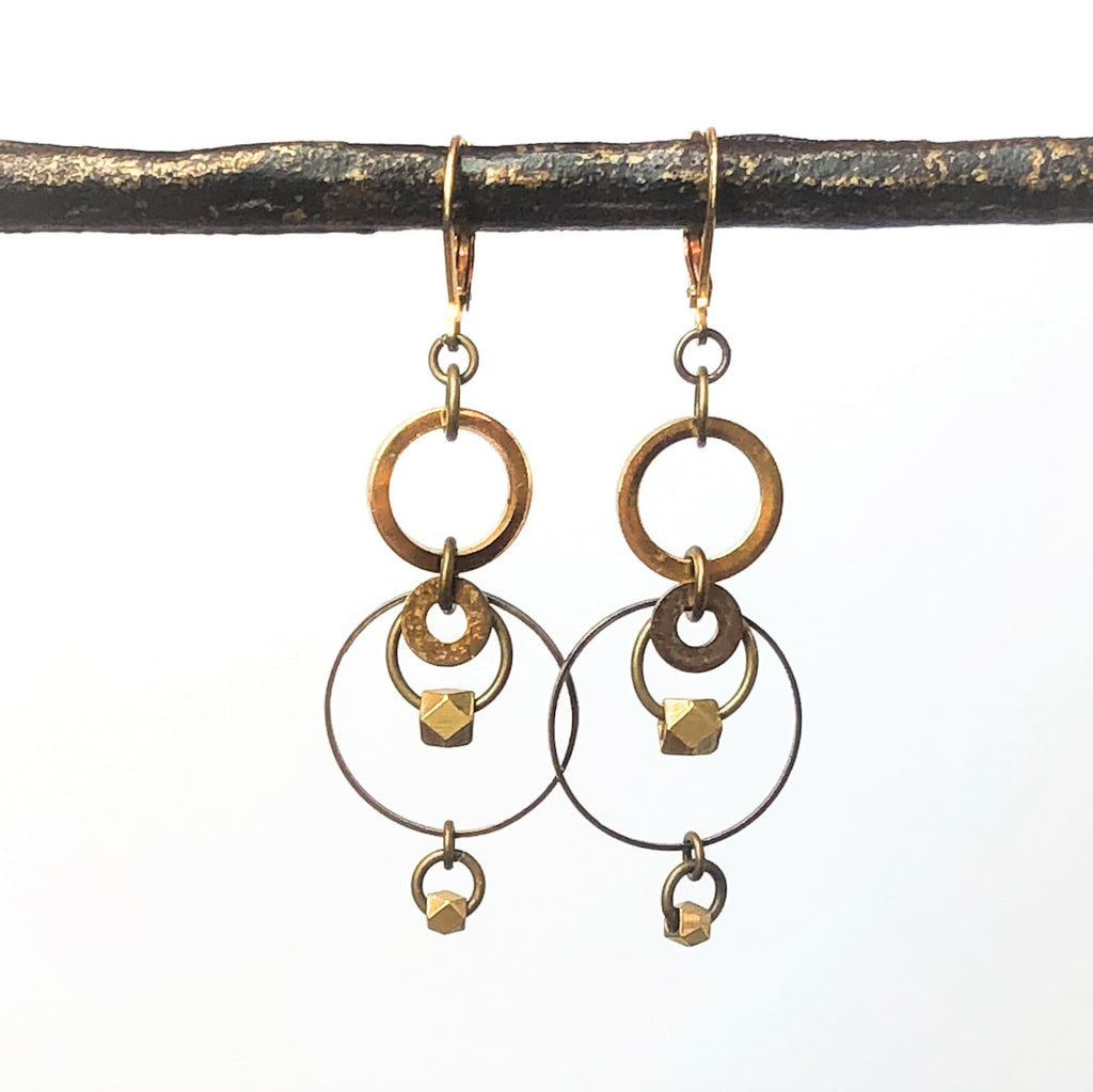 Brass concentric circles drop earrings on white background