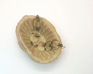 Brass three tiered drop earrings in ceramic dish