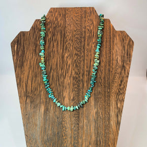 hand knotted turquoise nugget necklace shown on wooden necklace display