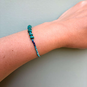 Hand knotted turquoise, lapis and howlite heishi beaded bracelet shown on wrist