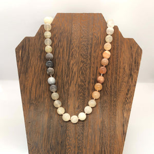 Hand knotted candy necklace with natural ombre moonstones and paper beads on wooden display