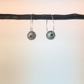 sterling silver hammered hoops with handmade silver paper bead shown on display
