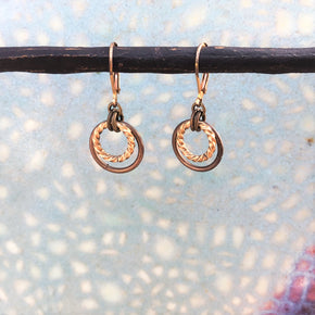 Brass two toned jump ring earrings oncolored background
